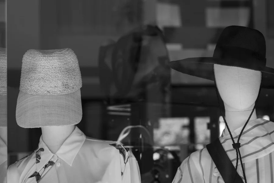 Mannequins wearing sun protection hats.