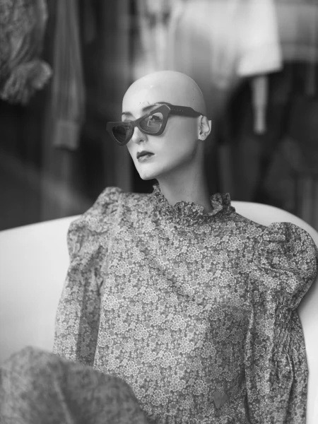 A shop mannequin wearing sunglasses.